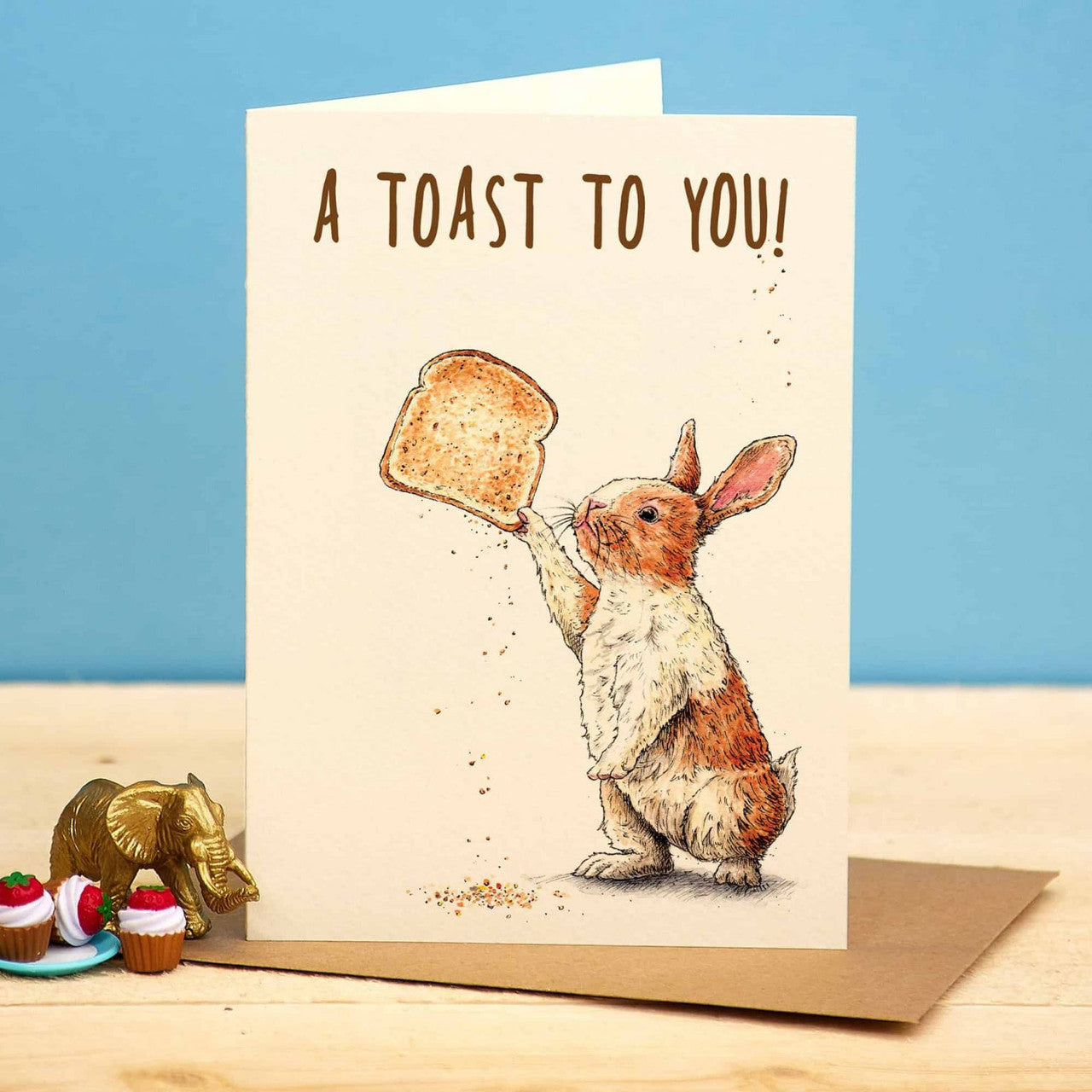 A Toast to You Greetings Card by Bewilderbeest.