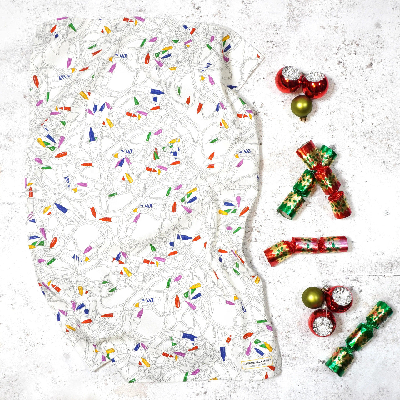 Christmas Lights Tea Towel by Corinne Alexander.
