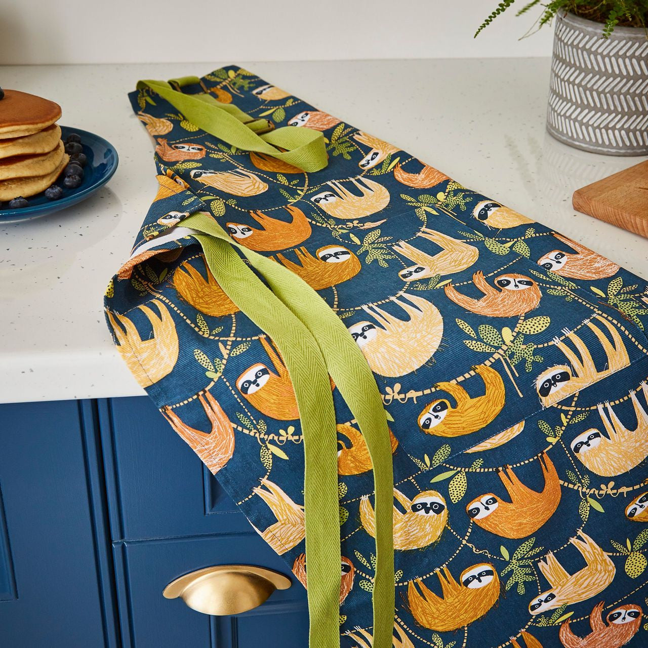 Hanging Around Cotton Apron from Ulster Weavers decorated with Sloths.