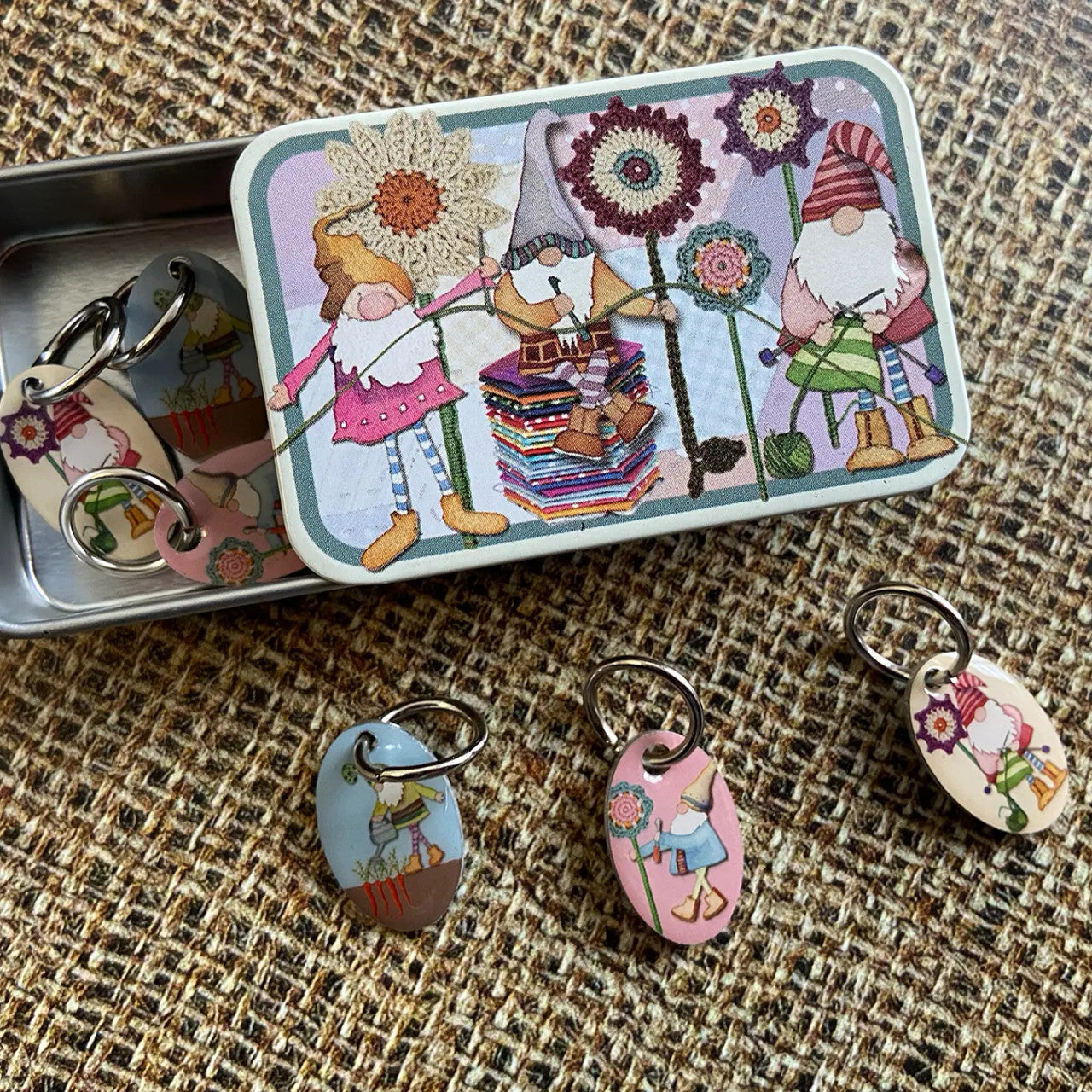 Crating Gnomes Set of 6 Stitch Markers in a Pocket Tin from Emma Ball.